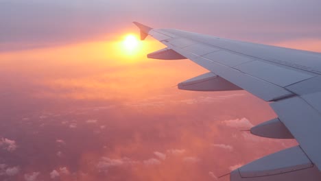 Window-point-of-view-of-the-sun-in-a-plane,-seeing-wing-aircraft.-Location-Paris